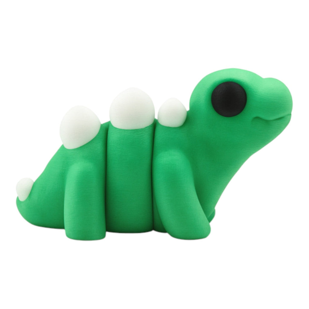 Tiny stegosaurusje groen-wit-zwart 7x3.5x3.5 cm zijaanzicht met rugplaten en articulated segmenten